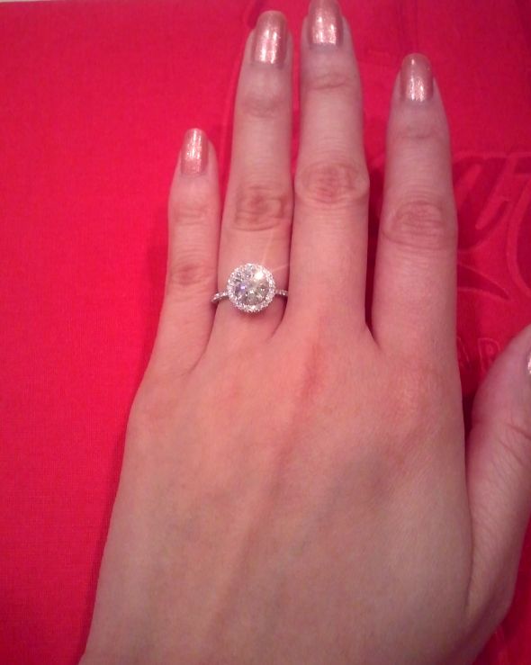 halo-engagement-ring-on-finger