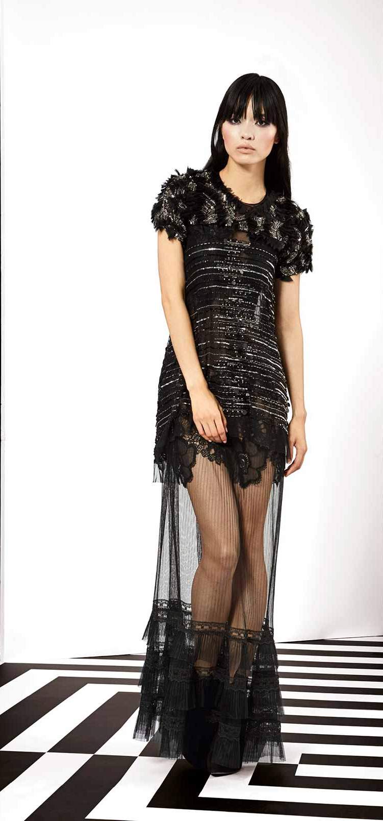 Long black party dress with very modern silhouette. Made of a combination of different fabrics such as fine French Chantilly laces, black silks and tulles