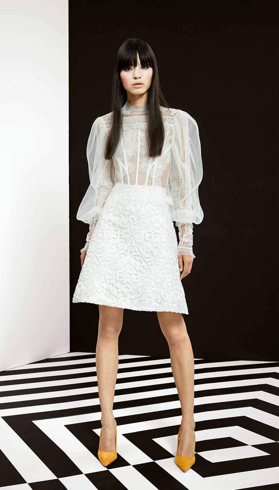 couture 2-piece ensemble. Romantic white blouse with bishop long sleeves and high-neck. White flared silk skirt